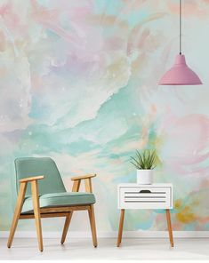 two chairs and a table in front of a wall painted with pastel paint on it