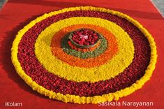 an arrangement of flowers arranged in the shape of a flowerpot on a red carpet