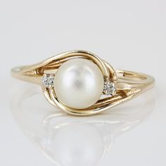 14k Yellow Gold Pearl Swirl Ring W/ Diamond Accent Stones This Is A Unique Ring Made Of 14 Karat Yellow Gold And Features A High-Quality Pearl In A Swirling Setting In The Center. The Pearl Is Accented Perfectly By Two Round-Cut Diamonds, Adding To The Overall Style. The Band Is A Size 7 But May Be Resized By Any Qualified Jeweler. "14k" Is Stamped Onto The Inside Part Of The Band. In Great Condition! Size: 7 (Resizable) // 1.2mm - 1.45mm Band Width // 8.4mm Setting Hgt. Metal: 14 Karat Yellow G Elegant White Diamond Ring With Birthstone, Oval Jewelry With A Modern Twist For Weddings, Elegant Yellow Gold Swirl Jewelry, White Jewelry With A Modern Twist For Anniversary, Modern Twist Oval Wedding Jewelry, Modern White Round Rings, Elegant Swirl Shaped Wedding Jewelry, White Modern Twist Ring Jewelry, Elegant Gold Bypass Ring With Gemstone