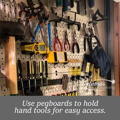 there are many tools on the pegboard to hold hand tools for easy access and storage