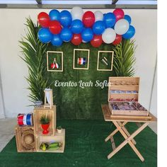 an event with balloons and decorations on the wall, including two small wooden crates filled with items