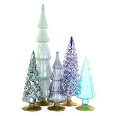 three different colored glass christmas trees on a white background