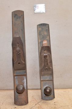 two old metal door handles on a wall