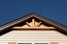 the top of a white house with wooden beams