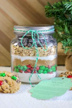 a jar filled with cookies and candy on top of a table