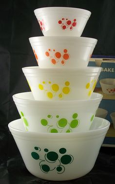 a stack of glass bowls sitting on top of a table