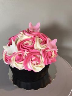 a cupcake decorated with pink and white icing