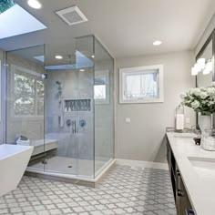 a bathroom with a tub, sink and large shower stall in it's corner