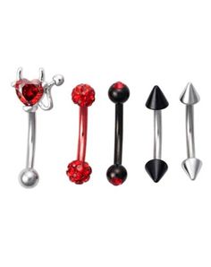 three different types of piercings with red crystal balls and black spikes on each side