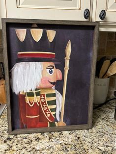 a painting of a nutcracker is on the kitchen counter next to some utensils