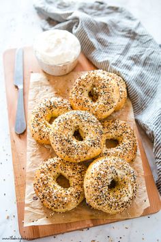 bagels with poppy seed sprinkles on a cutting board