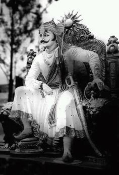 an old photo of a woman sitting on a chair with a cat nearby in black and white