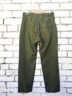 "Vintage Mens British Army Issue Work Trousers - Olive Green - Various Sizes - ADJUSTABLE Fantastic Grade A true vintage British military work pants in a mid-weight cotton blend. Tailored and flattering easy to wear design that makes them ideal for wearing day to day. We have these available in sizes 24\"-38\". Features - 1 buttoned back pocket - Wide belt loops - Zip and button fly - Waist adjusters at the side which tighten (so if unsure size up and bring in to fit) - Deep slashed side pockets Full Length Military Cotton Cargo Pants, Military Style Cotton Bottoms With Hip Pockets, Military Cotton Bottoms With Hip Pockets, Fitted Military Cotton Bottoms, Fitted Military Style Cotton Bottoms, Fitted Cotton Military Bottoms, Flat Front Cotton Work Pants With Pockets, Solid Cotton Flat Front Work Pants, Vintage Bottoms With Pockets In Solid Color