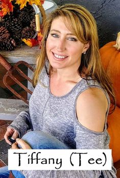 a woman sitting in front of pumpkins with the words tiffany written on her chest