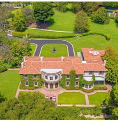 an aerial view of a large home surrounded by trees