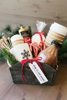 a basket filled with hot chocolates, marshmallows and candy canes