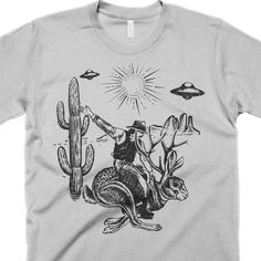 Jackalope and UFO T-Shirt. Browse our super cool collection of Funny and weird graphic tees and novelty gifts. New Tees added weekly. Our tee shirts are available for men, women, and kids. Come check it out now! Yucaipa California, Earth Clothes, Funny Shirts For Men, High Quality Clothing, Soft Hands, Clothing Size Chart, Soft Hand, Novelty Gifts, Super Cool