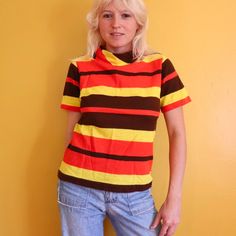 Vintage 1970s red / yellow / brown striped top or t shirt. Bust 36, length 26. Tag was cut out so don't know the fabric but it's super soft and perfectly worn in. Classic retro colors.    For more colorful vintage goods and groovy 70s clothes, check out my Instagram @magicbusvintage 70s 60s 1960s pinstripe blouse short sleeved tee horizontal stripe groovy hippie Fitted Brown 1970s Style Tops, Fitted Yellow Retro T-shirt, Yellow Fitted Retro T-shirt, 70s Striped Shirt, 1970s Retro Print Cotton Top, Blouse Short Sleeve, Yellow Stripes, Retro Color, Striped Shorts