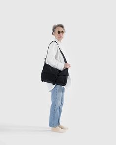 A functional, go-to bag with two large exterior pockets in addition to the main interior compartment. Has an interior laptop sleeve with velcro closure that fits 13/14” laptop in a puffy case. Bag Dimensions: 10 in. H x 14.5 in. W x 4.5 in. D Exterior Front Slip Pockets (x2) : 7.5 in H x 8 in. W Interior Back Computer Pocket: 14.5 in. W (Fits a 13/14" computer in our Puffy Sleeve) Adjustable Strap: 45 in Machine wash cold Body: 100% Nylon (59% Recycled) / Lining: 100% Nylon (40% Recycled) Baggu Bags, Fashion Reference, Insulated Lunch Bags, Reusable Bags, Tote Backpack, Laptop Sleeve, Laptop Sleeves, Messenger Bag, Laptop