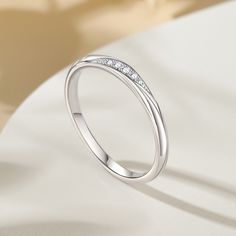 Simply and chic, this band is a clever accessory you will love. Featuring white stones, this band is an elegant symbol of your marital commitment. Buffed to a brilliant luster, this comfort-fit wedding band  will make your vows shine.Carat Weight: 0.086 ctStone Size: 1.1,1.3,1.5 mmStone Type: Jeulia® StoneNumber of Stones: 5 Stone Color: Diamond WhiteStone Shape: RoundWeight: 1.6 gWidth: 1.8 mmHeight: 1.8 mmThickness: 1.1 mmMaterial: 925 SilverPlating Color: Silver Elegant Symbol, Comfort Fit Wedding Band, White Stones, White Stone, Quality Jewelry, Wedding Band, Round Cut, Stone Color, Wedding Bands