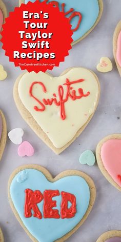 some heart shaped cookies with the words swifties on them and red writing in the middle