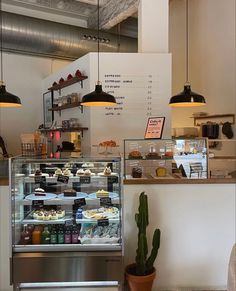 the inside of a pastry shop with cactus and sushi