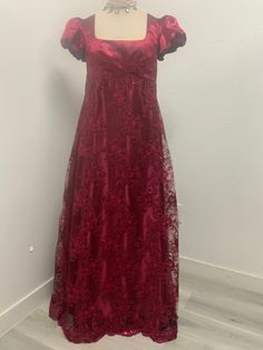 Beautiful burgundy/wine dress made with embroidered sequined mesh over satin perfect for the regency ball or tea party very shiny . Please not it takes me 5-8 business days to produce and ship your dress after order is placed . THERE IS NO RETURNS OR EXCHANGES ACCEPTED PLEASE BE SURE TO CHECK THE MEASUREMENTS ON THE BOTTOM OF THE DESCRIPTION. If for any reason the measurements don't match with yours be sure to provide to me at the time of order. PLEASE NOTE COLOR MAY BE A LITTLE DIFFERENT ONCE Y Regency Dress Casual, Red Regency Gown, Sanditon Dresses, Burgundy Ball Gown For Party, Burgundy Ball Gown Evening Dress For Party, Burgundy Ball Gown For Evening, Formal Empire Waist Evening Dress For Prom Season, Elegant Burgundy Ball Gown Evening Dress, Victorian Satin Ball Gown For Party