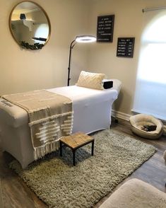 a white bed sitting on top of a wooden floor