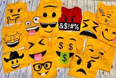 a group of yellow shirts with faces drawn on them sitting on top of a wooden floor