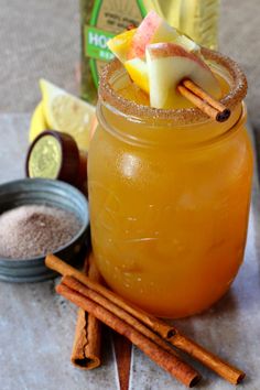 an apple cider cocktail with cinnamon and apples