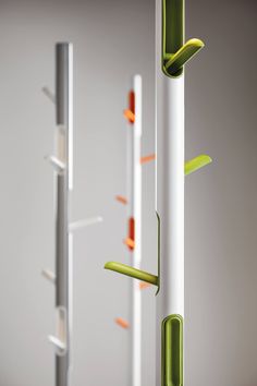 three white and green poles with orange handles