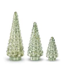 three small glass christmas trees sitting next to each other