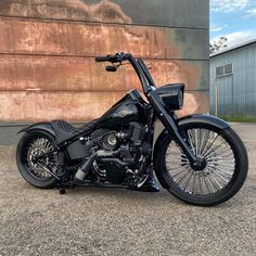 a black motorcycle parked in front of a building