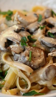 a close up of a plate of pasta with mushrooms