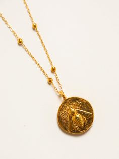 Bee of Ephesus/Stag Coin Necklace | Elysian by Emily Morrison. Yellow Gold Brass Coin Necklace As Gift, Gift Yellow Gold Coin Necklace In Brass, Engraved Medallion Gold Plated Necklace, Gold Sterling Silver Medallion Pendant Necklace, Yellow Gold Medallion Necklace With Large Brass Pendant, Symbolic Gold Plated Necklaces With Large Pendant, Gold Hallmarked Medallion Pendant Necklace, Gold Medallion Pendant Necklace In Sterling Silver, Symbolic Gold Plated Necklace With Coin Pendant