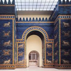 an ancient building with blue and gold paint on it's walls, decorated with animals