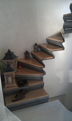 a set of stairs leading up to a room with lanterns on the top and bottom