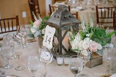 the table is set with candles, flowers and place cards for guests to sit at