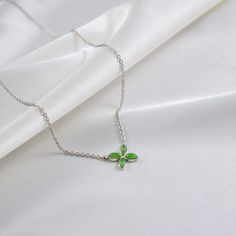 A symbol of life, transformation, and freedom - just like its namesake. The jade Ava necklace symbolizes our well wishes for your year ahead to be filled with hope, luck, and love. Green Clavicle Chain Necklace For Gift, Gift Green Clavicle Chain Necklace, Green Charm Necklaces With Clavicle Chain For Gift, Green Flower Pendant Necklace As Gift, Green Pendant Charm Necklace With Adjustable Chain, Dainty Green Flower Pendant Jewelry, Spiritual Green Jewelry With Adjustable Chain, Green Sterling Silver Jewelry For Good Luck, Green Flower Pendant Necklace For Gift