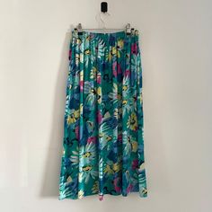 Description: Vintage Turquoise St Michael Multicoloured Elasticated Midi Skirt. Made in the UK Measurementsstrong>Waist: 68cm, Length: 78cm, Hips: 70cm Turquoise Lined Skirt Bottoms For Spring, Turquoise Lined Skirt For Summer, Green Pleated Skirt For The Beach, Long Turquoise Skirt For Summer, Turquoise Long Skirt For Spring, Turquoise Long Skirt For Summer, Retro Green Long Skirt Bottoms, Turquoise Skirt For Spring, Green Midi Skirt With Elastic Waistband