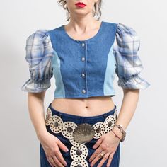 One of a kind handmade bavarian style crop top in blue with plaid puff sleeve top in printed floral pattern - buttoned down at the front - materials: denim, cotton SIZE from the tag: no tag Best fits women: M MEASUREMENTS bust: 36 inches (92 cm) length: 15.5 inches (39 cm) The model is 5'9" (174 cm), measures 35-27-38 (89-69-96 cm) and typically wears clothing in size M Fitted Cotton Crop Top With Puff Sleeves, Trendy Fitted Short Sleeve Denim Top, Summer Puff Sleeve Top With Patchwork, Fitted Short Sleeve Denim Top For Fall, Trendy Fitted Patchwork Blouse, Fitted Plaid Puff Sleeve Blouse, Plaid Fitted Blouse With Puff Sleeves, Fitted Plaid Blouse With Puff Sleeves, Fitted Cotton Cropped Shirt For Spring