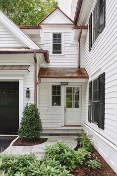 a white house with black doors and windows