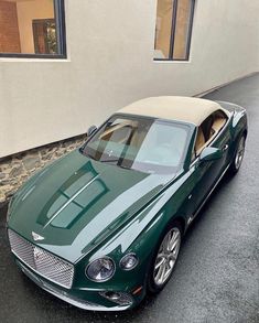 a green car parked in front of a building