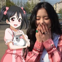 a woman holding her hands to her face while standing in front of an anime character