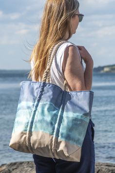 With this tote on your shoulder, you can instantly imagine yourself at the shore. The design was inspired by the process of tie dying, which yields the subtle gradations in tones that emerge to represent breaking waves on a sandy beach. You’ll be impressed with the capacity—it’s a family-sized carryall for the beach, sports events, and travel. The rugged handles wrap around the bag for added support and the recycled sail cloth has water-resistant properties. Cloth Tote Bags, Sail Cloth, Recycled Sailcloth, Sail Bag, Boat Bag, Breaking Waves, Perfect Beach Bag, Boat Tote, Big Tote Bags