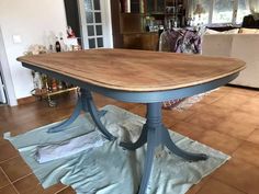 a wooden table sitting on top of a tile floor