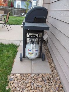 a gas tank sitting on the side of a house