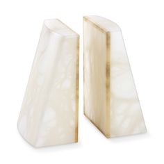 two white marble bookends sitting next to each other