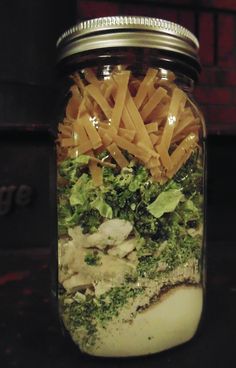 a mason jar filled with pasta and veggies