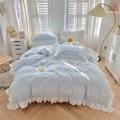 a bed with blue comforter and pillows in a room